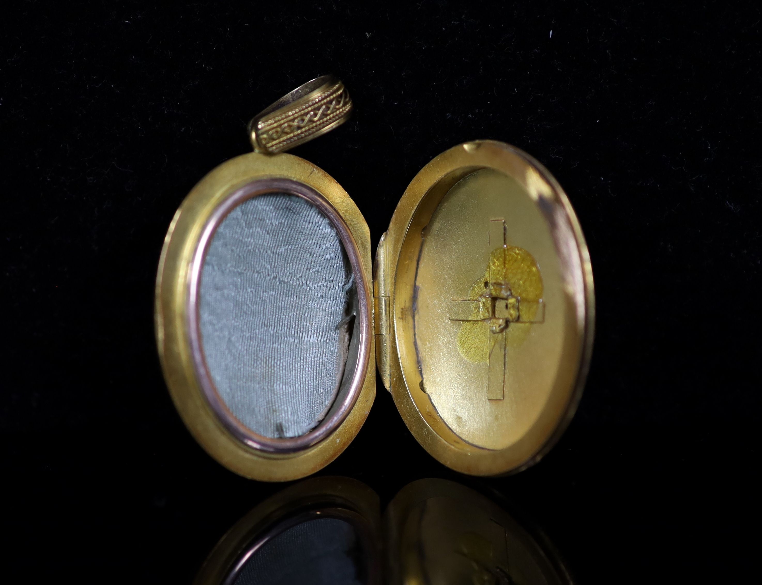 A Victorian gold and three stone turquoise set oval locket